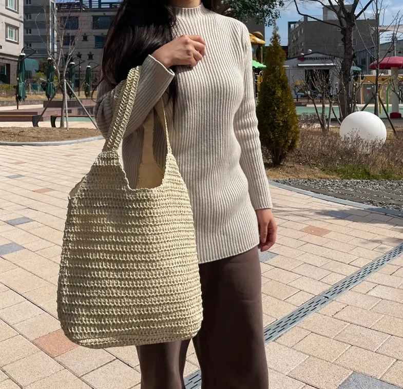 Beige rattan bag worn for everyday use