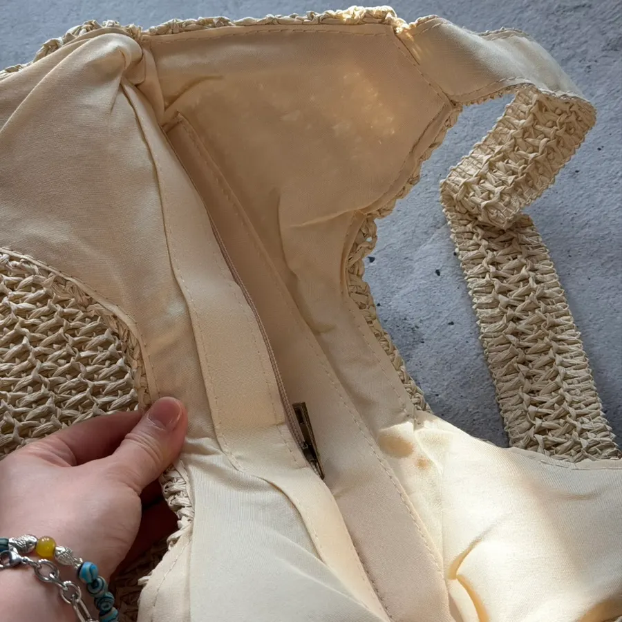 Inside space of the Meda Bag rattan bag holding personal items