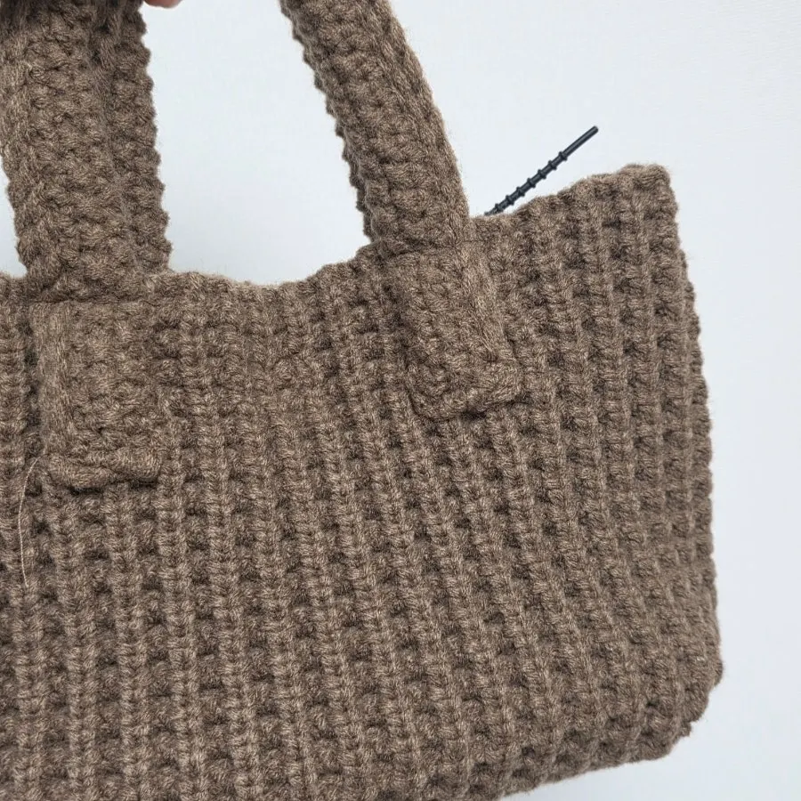 Knit mini tote bag carried for a weekend outing
