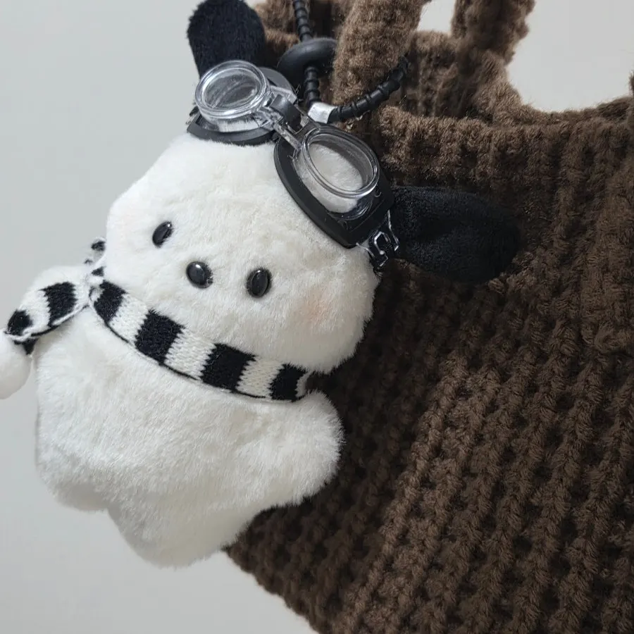 Keychain detail on the brown Meda Bag knit bag