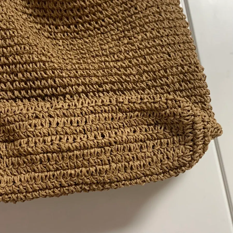 Shape and bottom section of the brown Meda Bag rattan bag