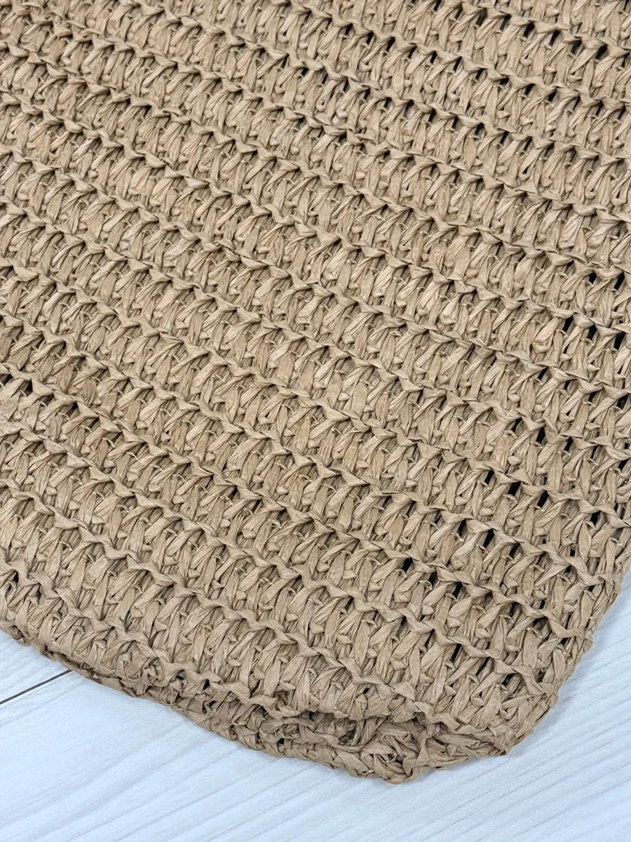 Densely woven net section of the Meda Bag rattan bag