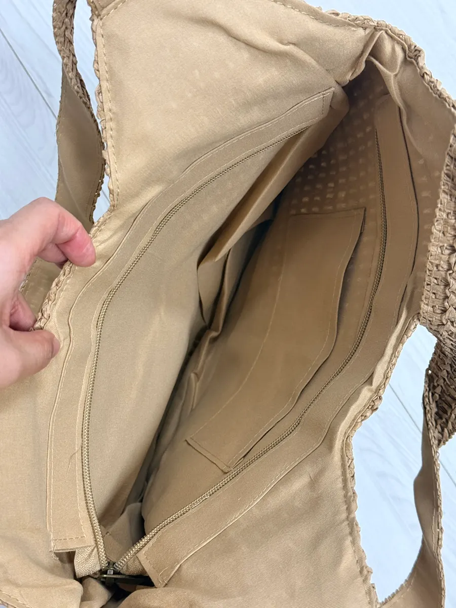 Opening and interior storage space of the Meda Bag rattan bag