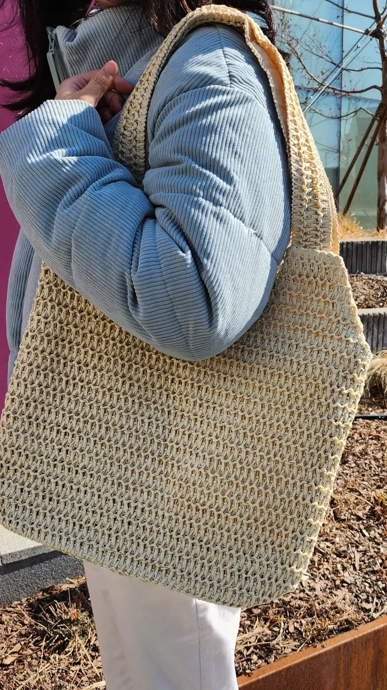 Ivory Meda Bag rattan bag carried on an outing