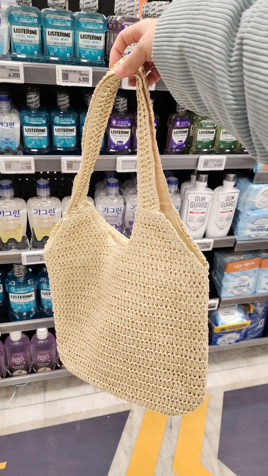 Ivory Meda Bag rattan bag lightly hooked over the arm