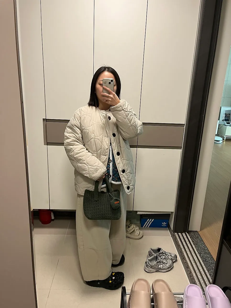 Green bag paired with winter outerwear