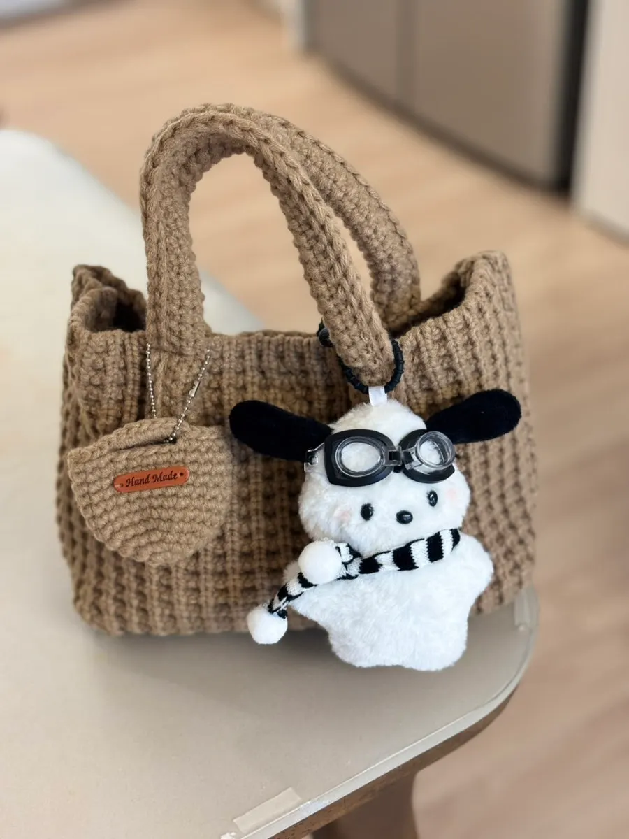 Knit tote bag styled with a puffer jacket