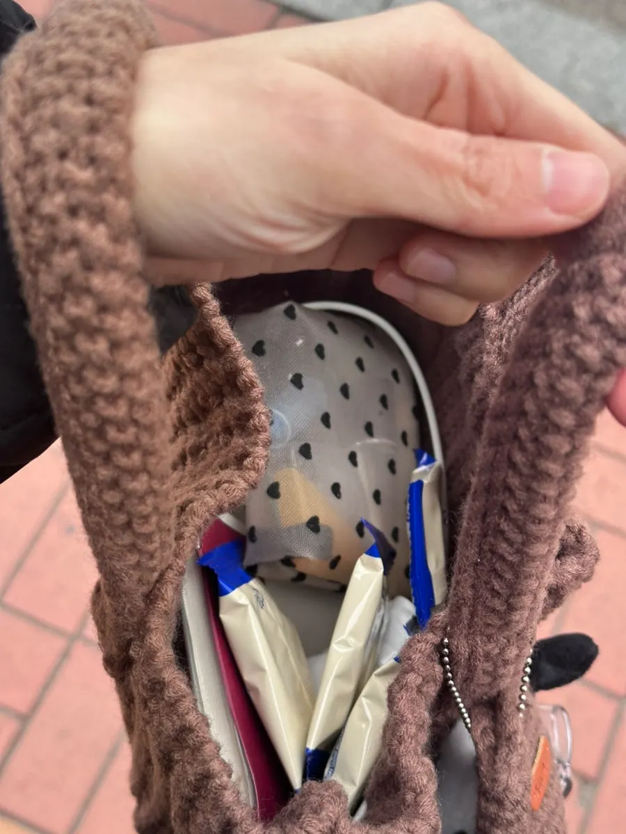 Brown knit bag carried with a winter outfit