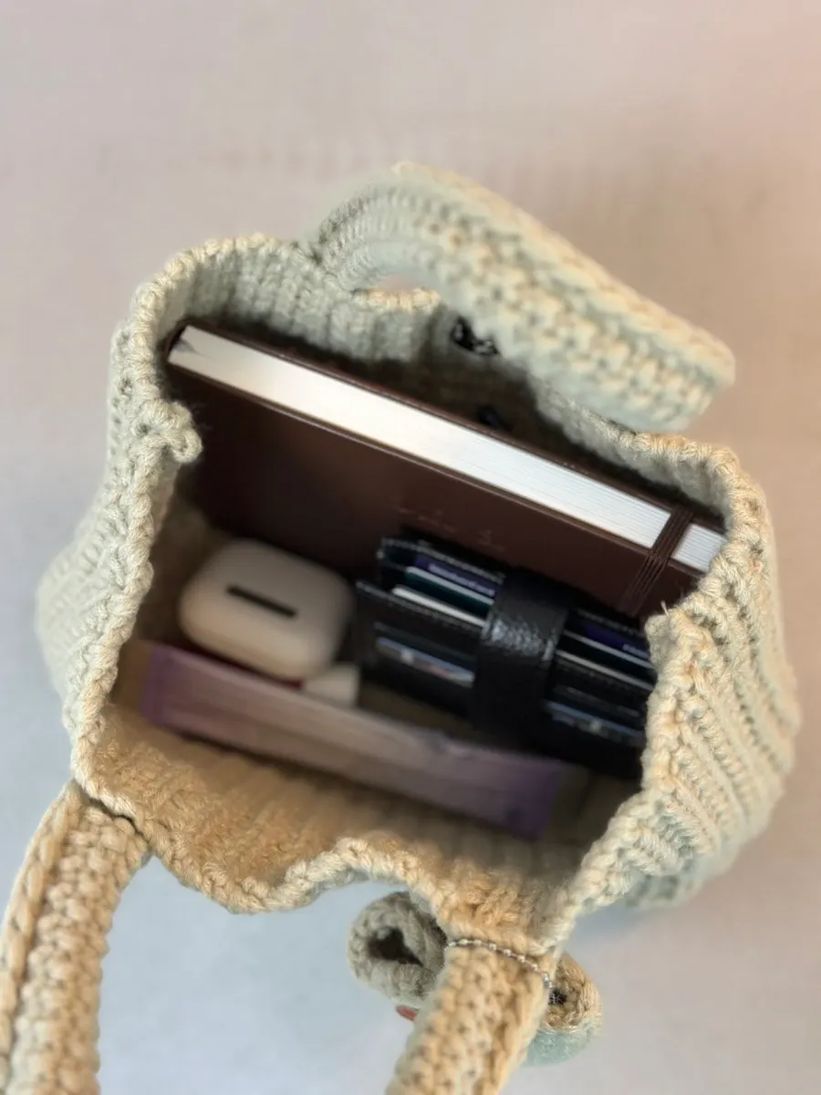 Knit mini tote bag filled with belongings