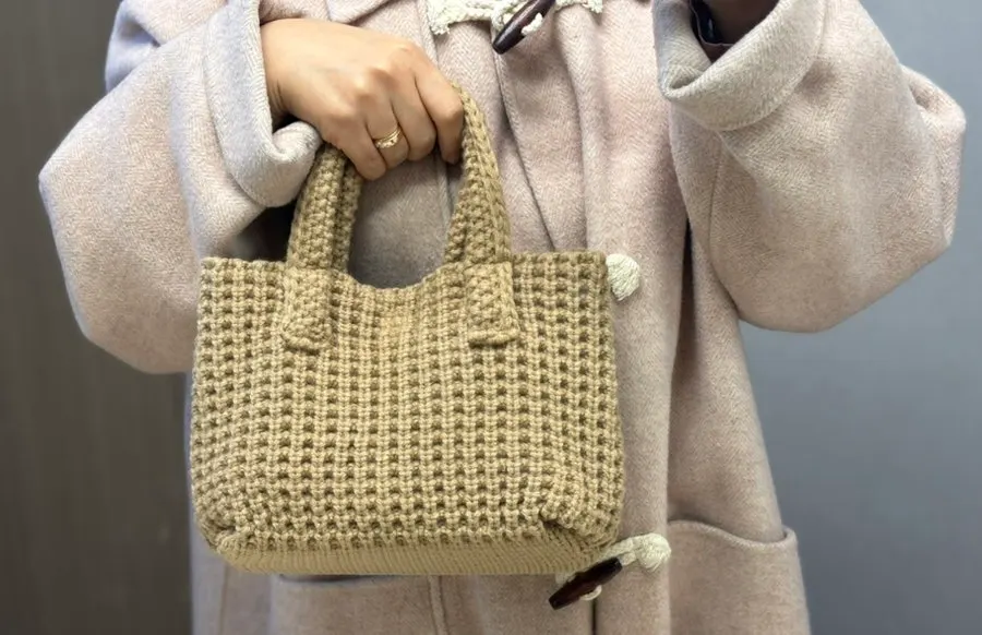 Beige knit tote bag in storage