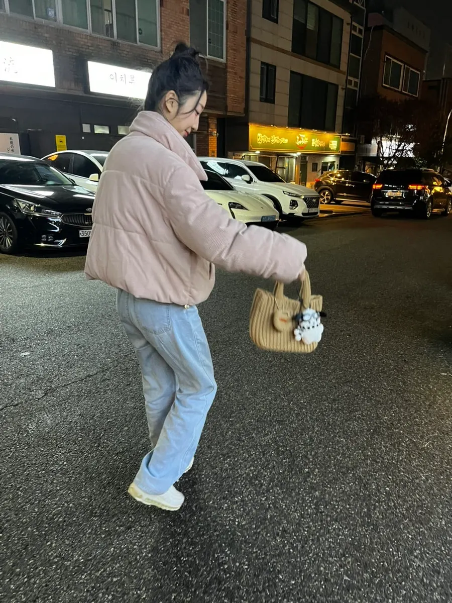 Brown knit tote bag held in hand