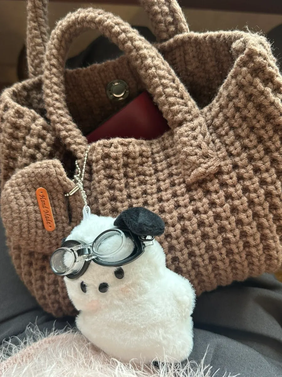 Brown knit bag carried with a coat