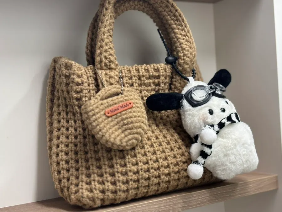 Knit mini tote bag carried with a coat