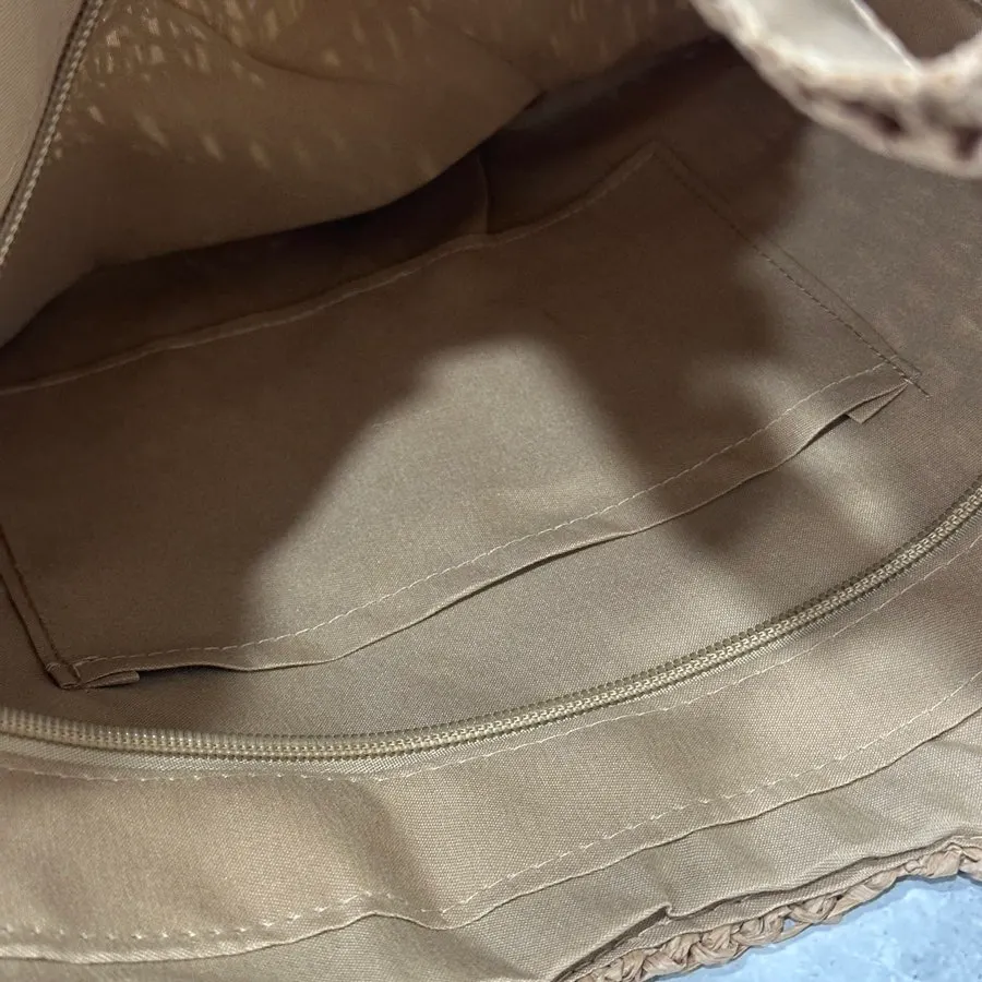 Opening and interior layout of the Meda Bag rattan bag