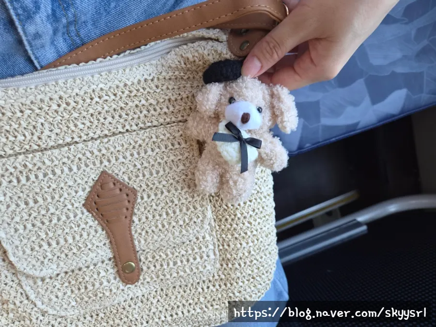 Meda Bag rattan crossbody bag worn with its generously long strap