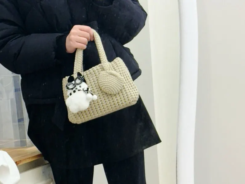 Mini dot bag holding personal belongings