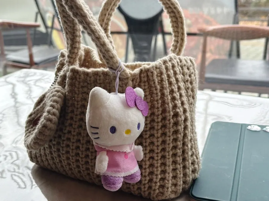Knit dot bag with its magnetic button closed