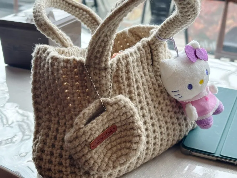 Ivory knit dot bag with a keyring attached