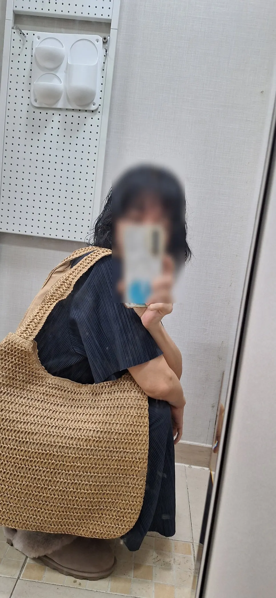 Beige rattan shoulder bag styled with a navy maxi dress