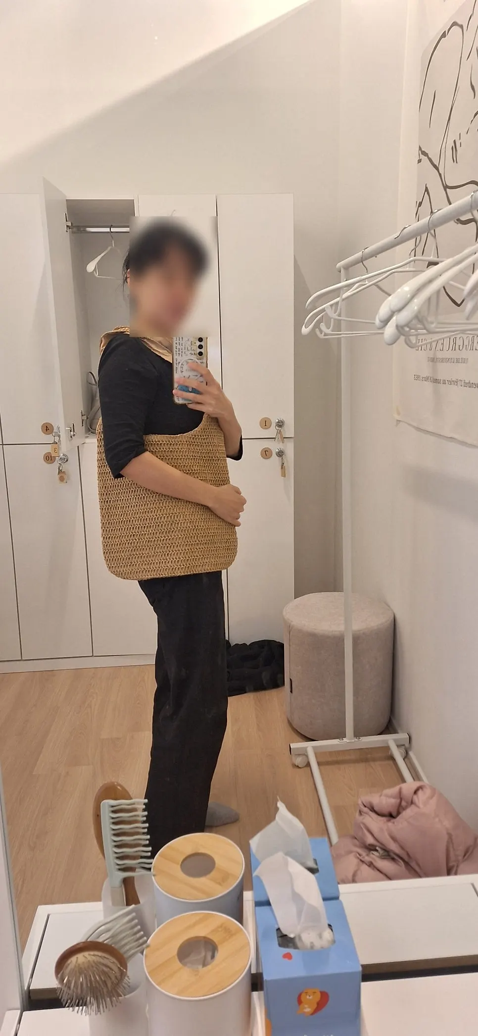 Rattan shoulder bag styled with a black top and slacks