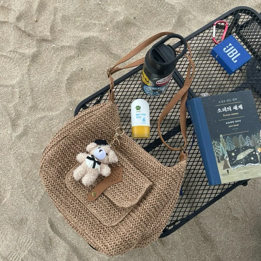 Medabag Rattan Bag decorated with a bear keychain