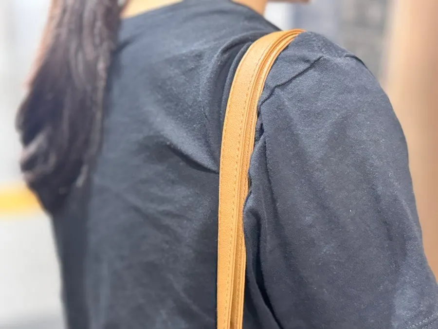 스트랩을 짧게 조절해 어깨에 멘 라탄백
