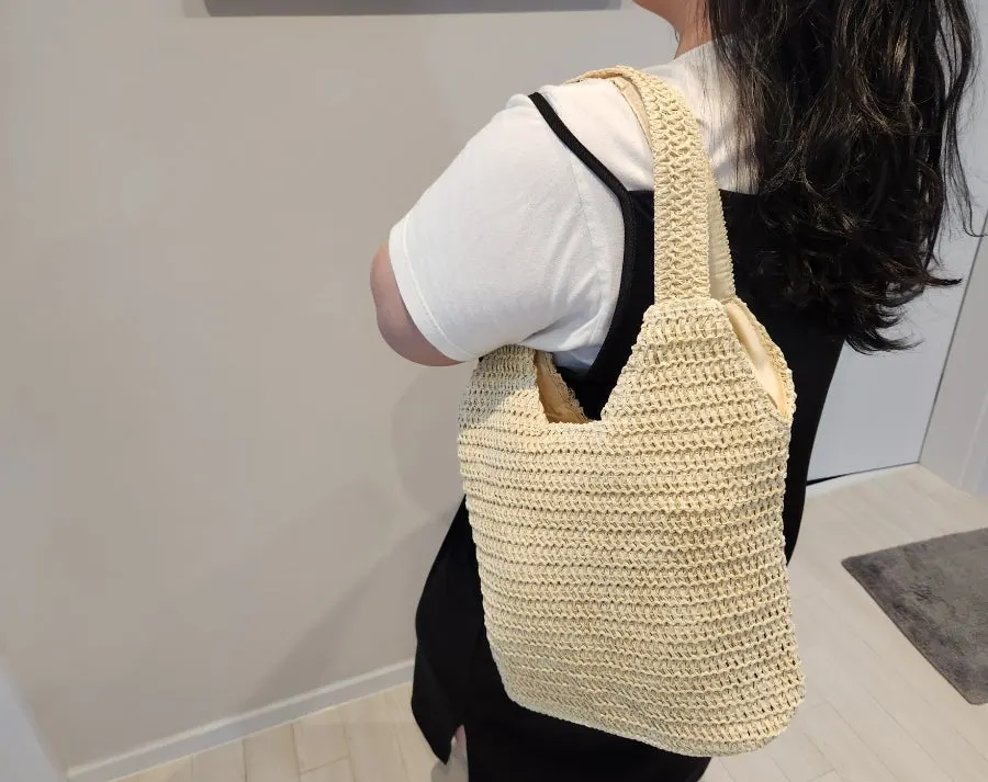 Rattan bag carried for a resort-like look