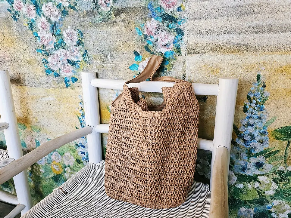 Meda Bag rattan bag carried with travel belongings inside
