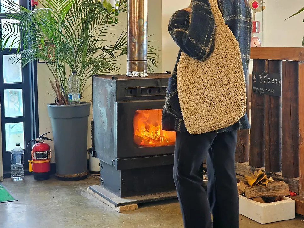Brown rattan bag paired with a travel outfit