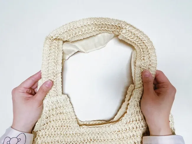 Rattan shoulder bag strap worn on the shoulder