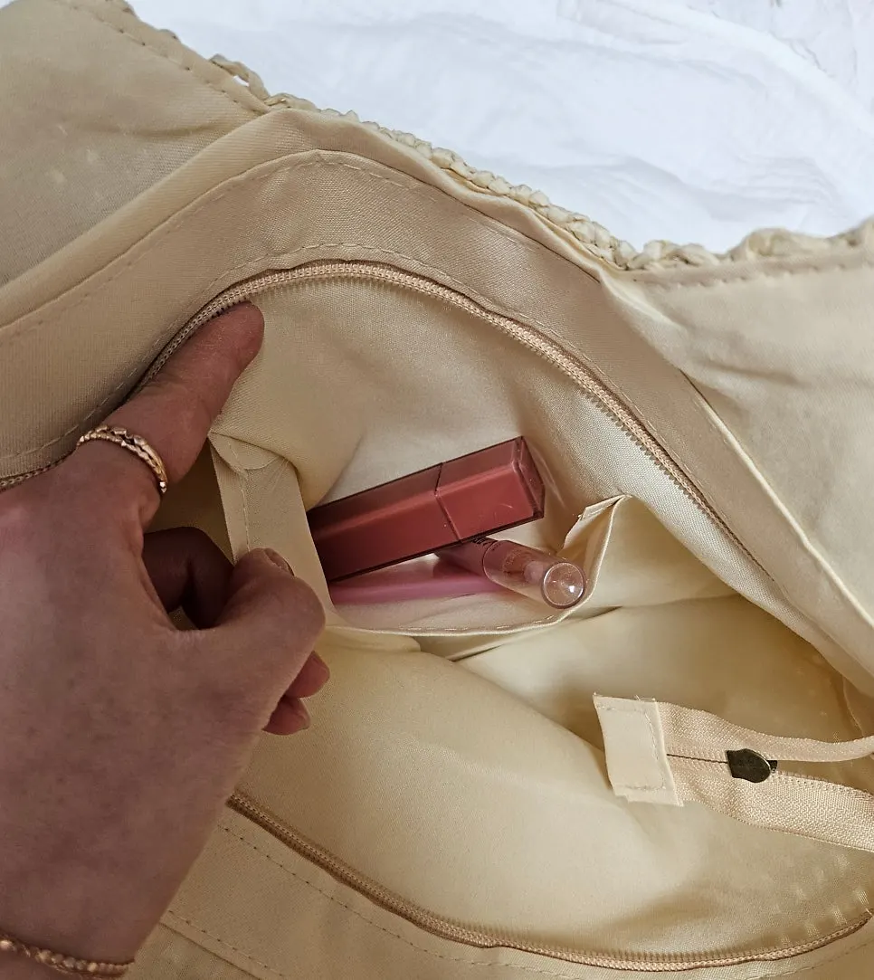 Rattan bag standing upright with the pouch inside