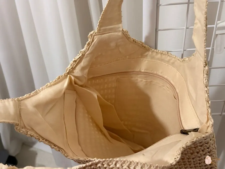 Inside of the Meda Bag rattan bag with a zip closure