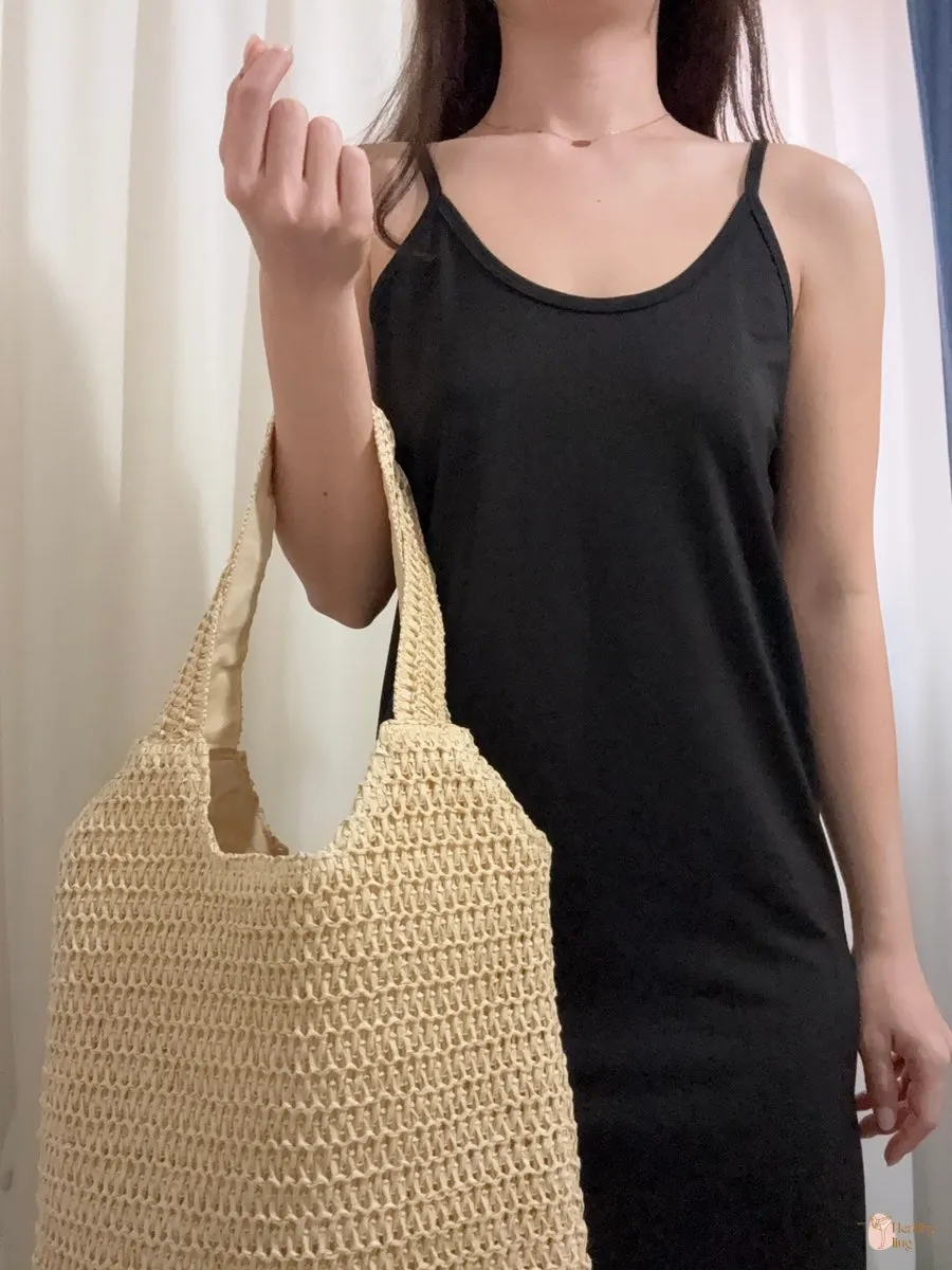 Rattan bag styled with a black sleeveless dress