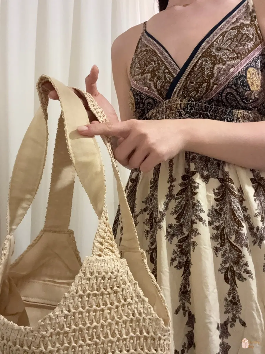 Wearing a Meda Bag rattan bag with a black dress