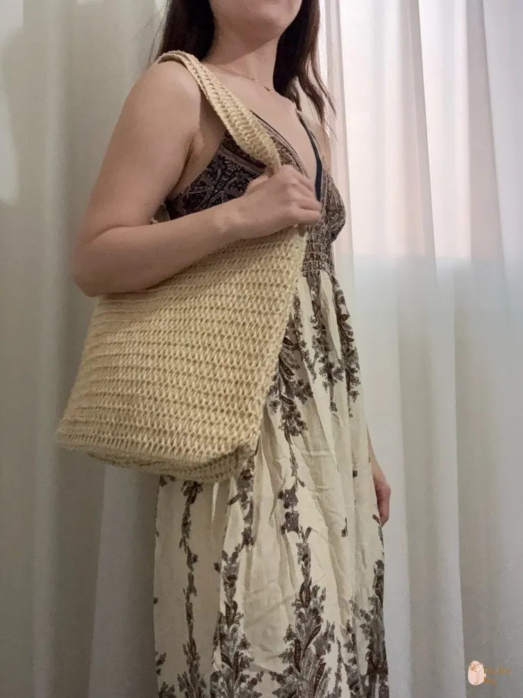 Bright rattan bag styled with a dress