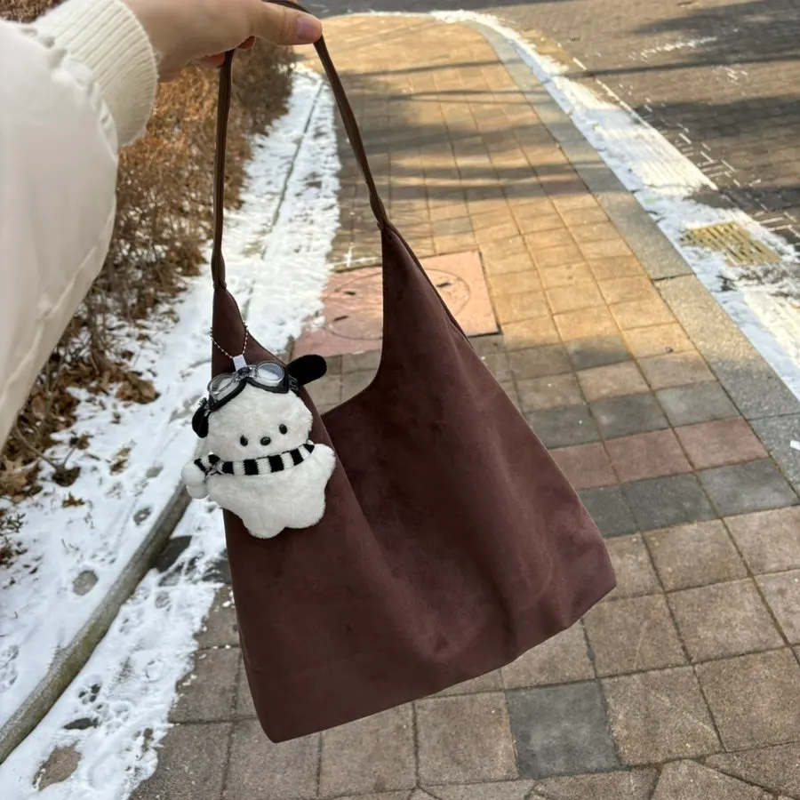 A suede bag carried on a short outing