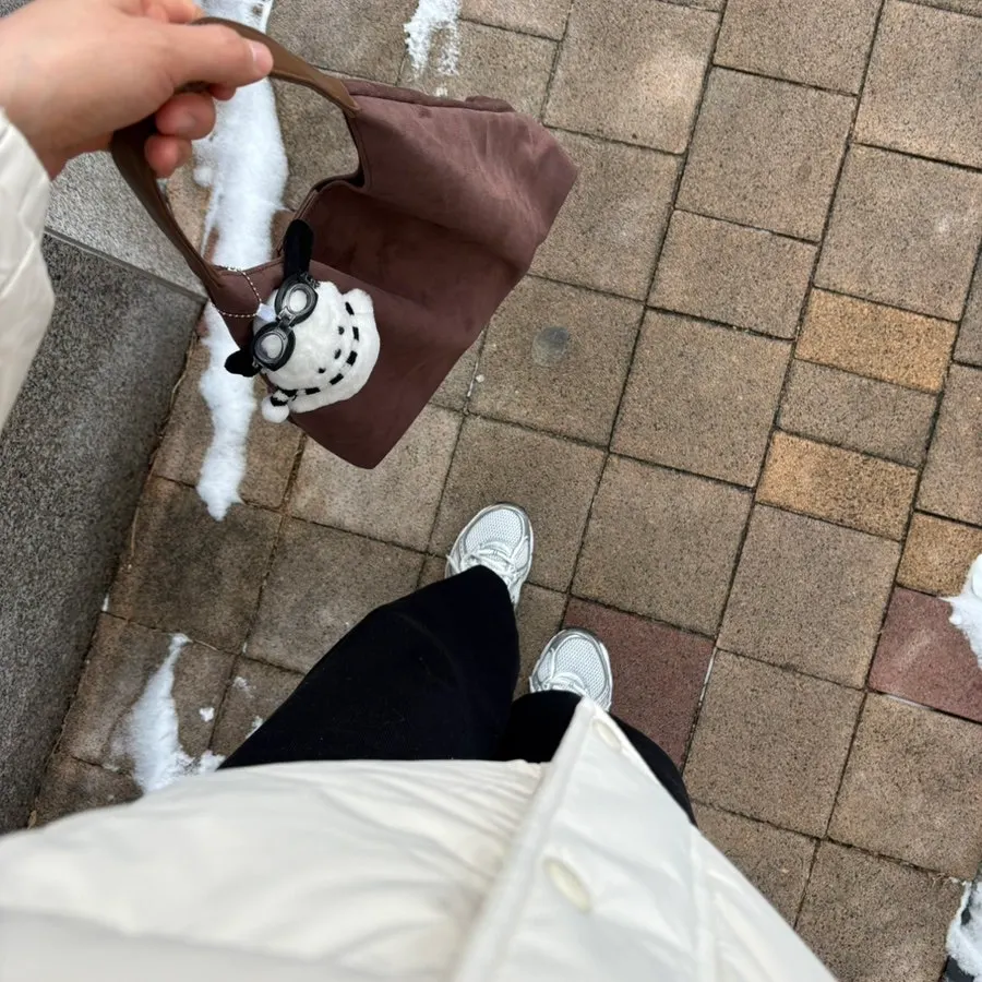 A suede bag carried to buy coffee