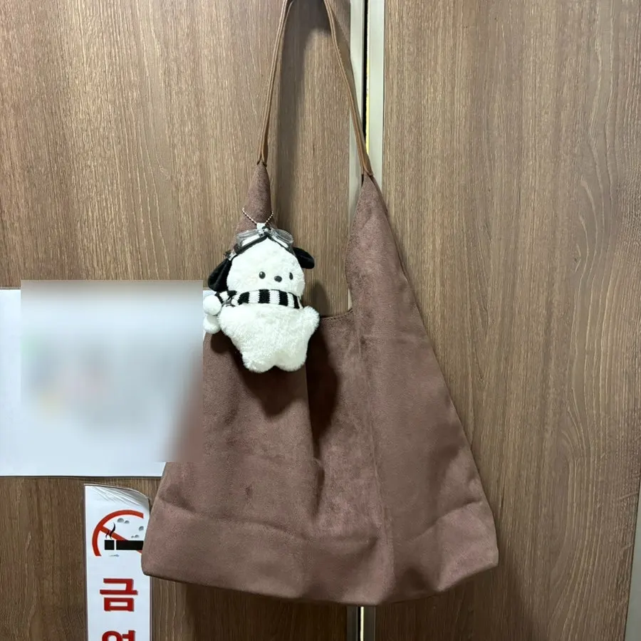 The brown suede bag used for storing belongings