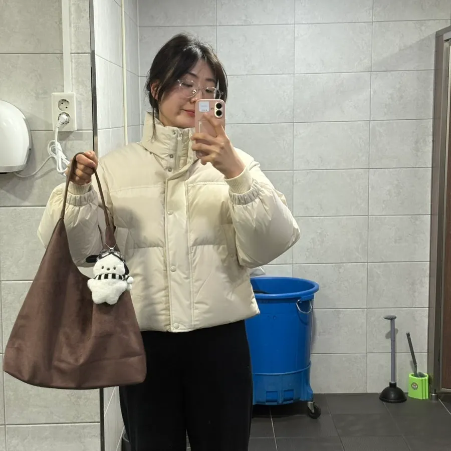 A doll included with the suede bag