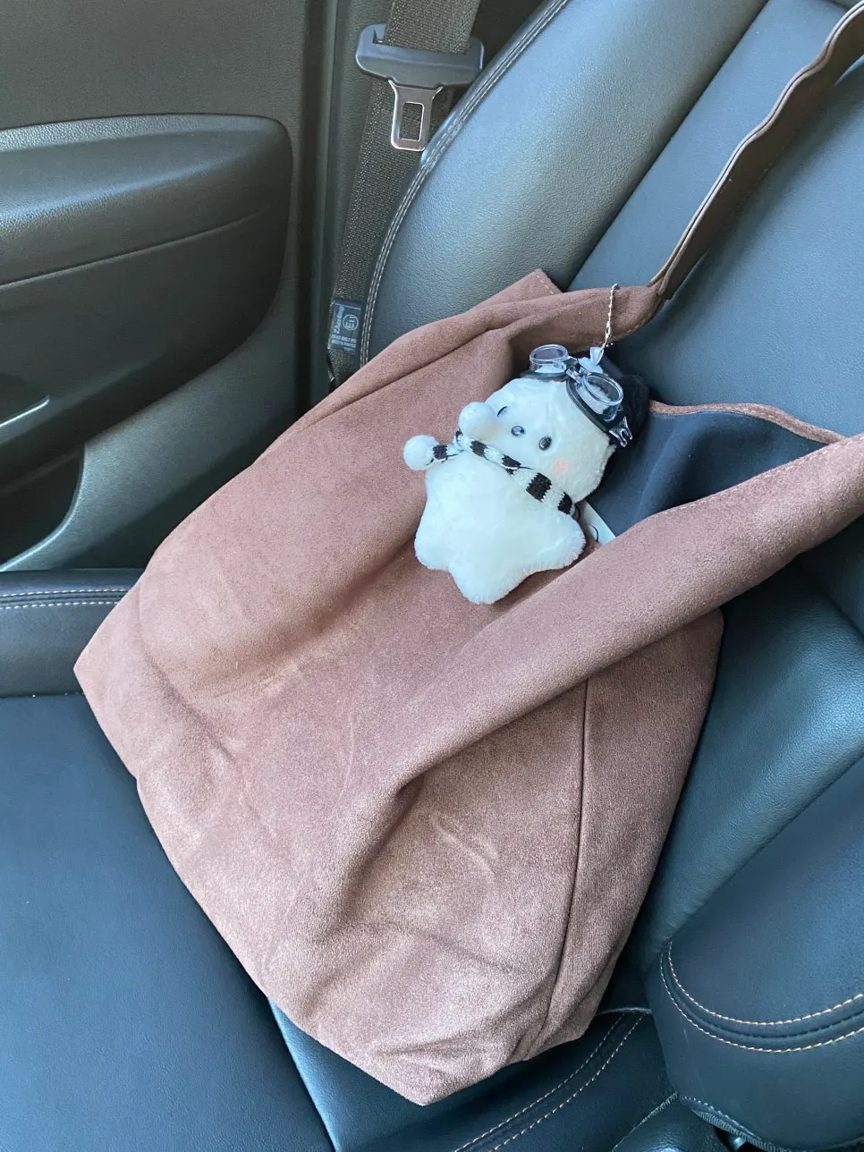 Camel Meda Bag shoulder bag carried with a long padded coat