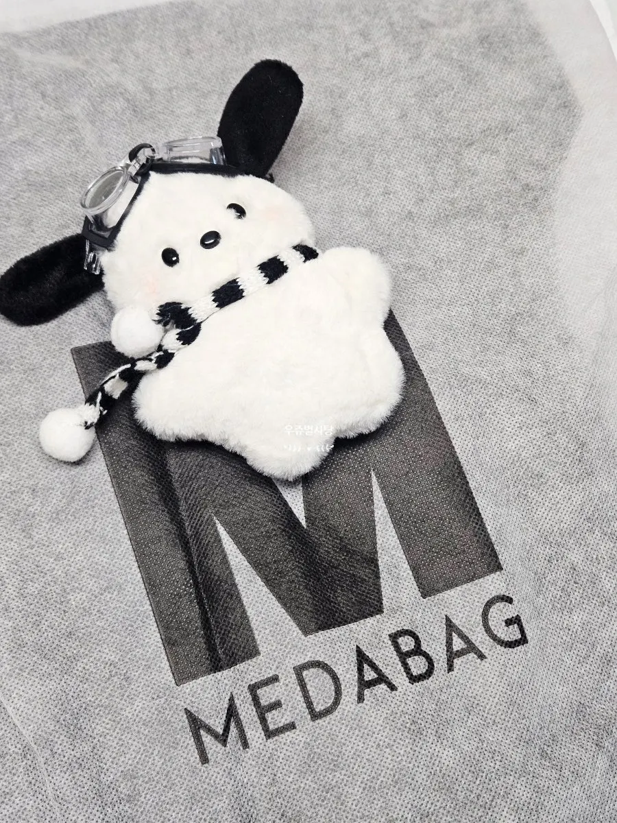Packaging and included items for the Meda Bag suede bag