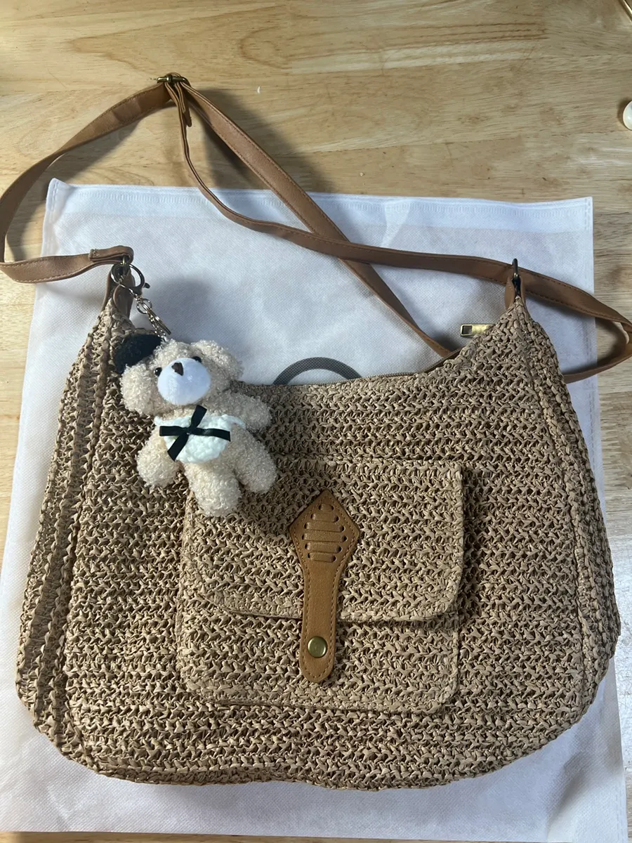 Brown rattan crossbody bag with a rounded silhouette