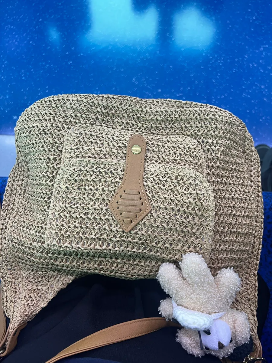 Brown rattan crossbody bag worn while out
