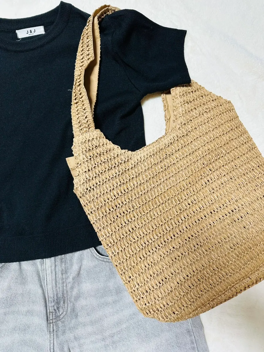 Rattan shoulder bag carried with a summer outfit
