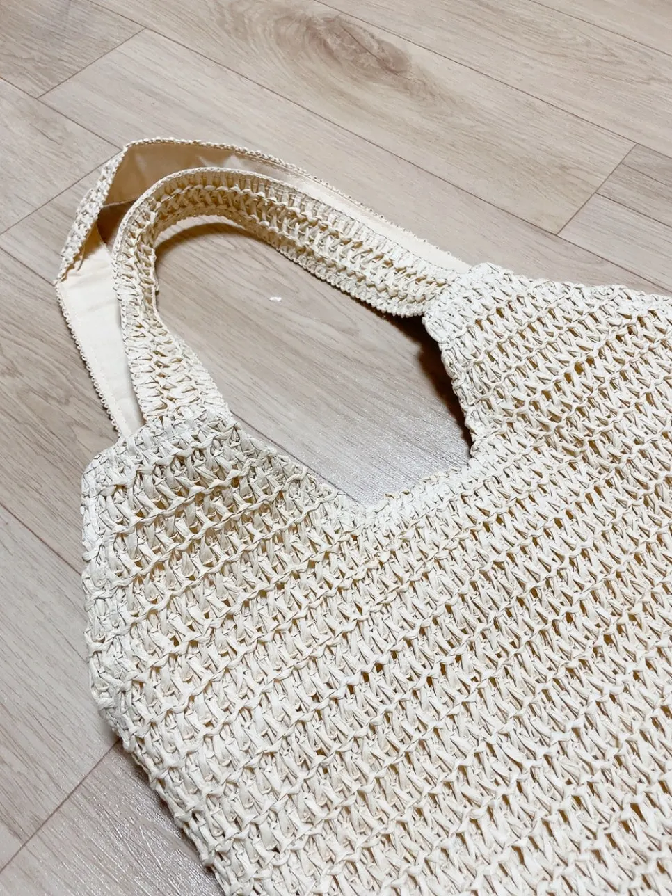 Rattan shoulder bag packed with belongings