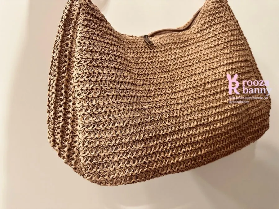 Rattan crossbody bag used to carry travel belongings