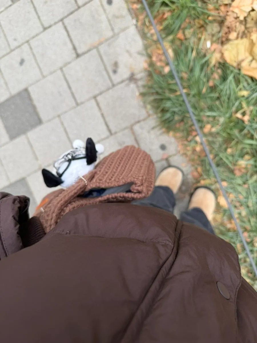 Brown tote bag carried with a fall and winter outfit