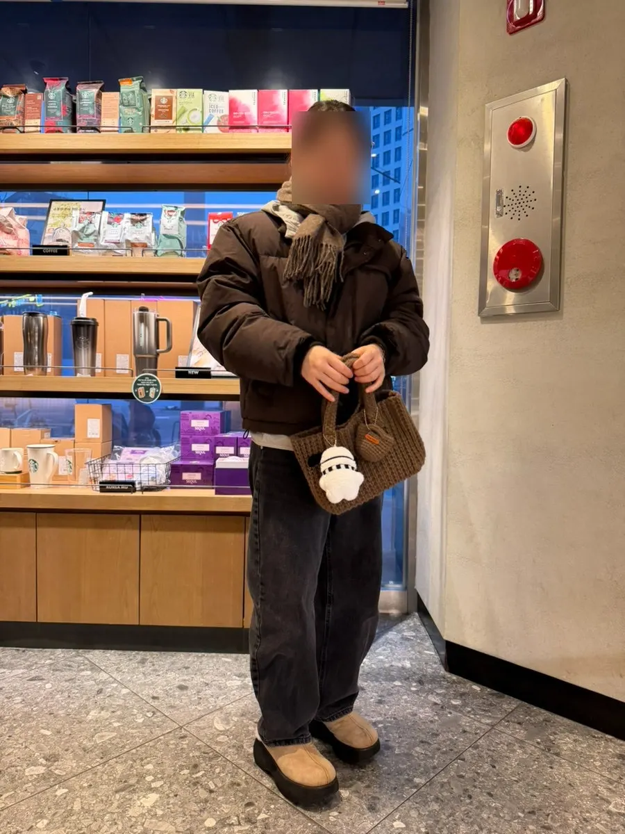 Brown mini tote bag held in hand
