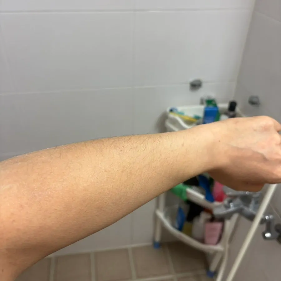 Applying tone-up milk with a shower sponge