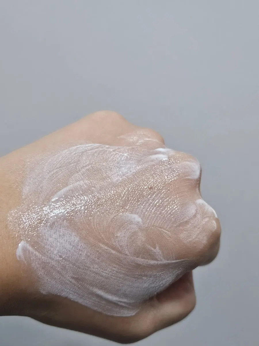 Moisturizing sunscreen texture swatched on the back of a hand